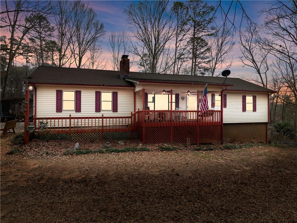 1527 Gold Mine Road Dawsonville, GA 30534 - Photo 2 of 39 a view of a house with a yard and large trees