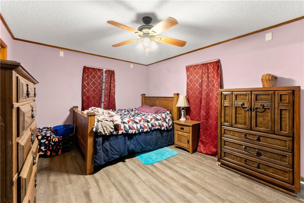 1527 Gold Mine Road Dawsonville, GA 30534 - Photo 22 of 39 a bedroom with a bed and wooden floor