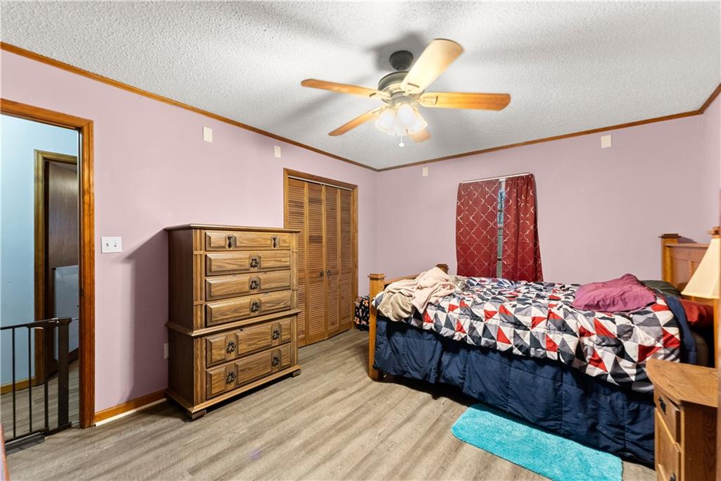 1527 Gold Mine Road Dawsonville, GA 30534 - Photo 23 of 39 a bedroom with bed and dresser