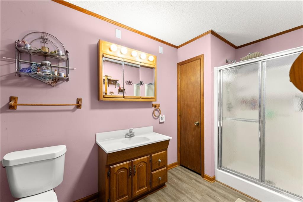 1527 Gold Mine Road Dawsonville, GA 30534 - Photo 24 of 39 a bathroom with a sink mirror and toilet