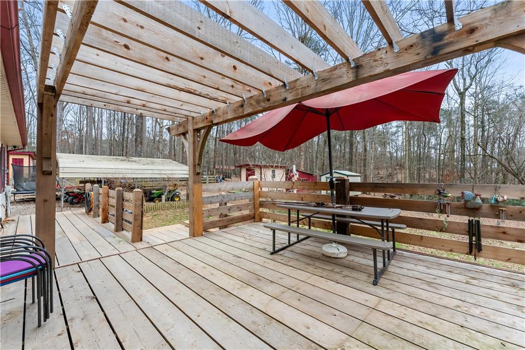 1527 Gold Mine Road Dawsonville, GA 30534 - Photo 27 of 39 a view of a rooftop deck with couch and chairs