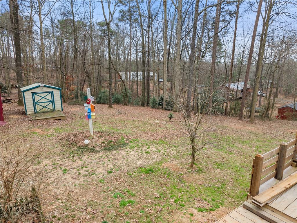 1527 Gold Mine Road Dawsonville, GA 30534 - Photo 31 of 39 a backyard of a house with lots of green space