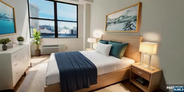 a bedroom with a bed and a painting on the wall