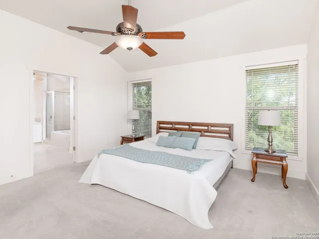 a bedroom with a large bed and a large window