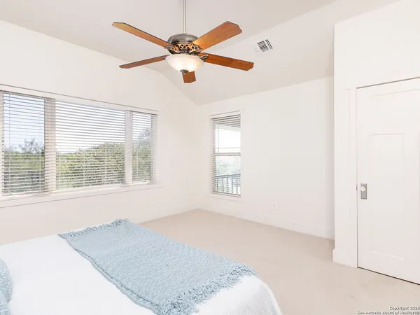 a bathroom with a tub a sink and a large mirror