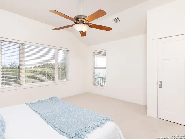 a bathroom with a tub a sink and a large mirror