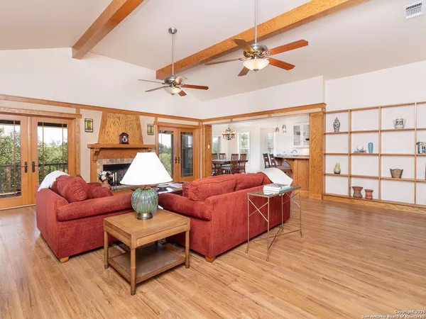 a bedroom with furniture and a large window