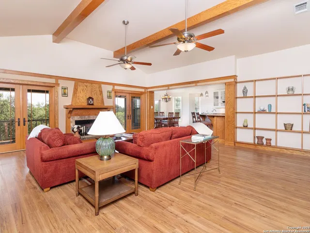 a bedroom with furniture and a large window