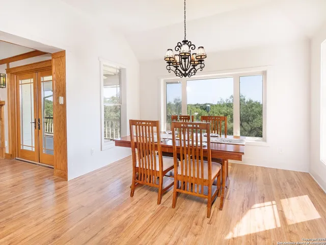 a view of a dining room with furniture wooden floor and chandelier