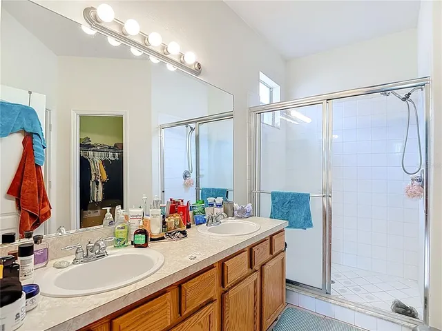 a bathroom with a granite countertop sink a shower and a mirror