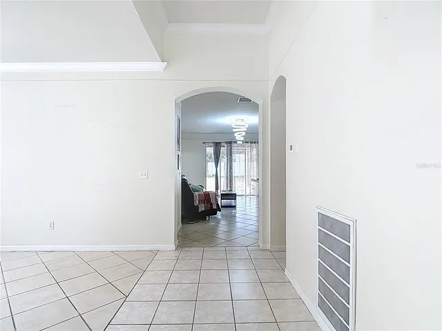 a view of a hallway with livingroom and furniture