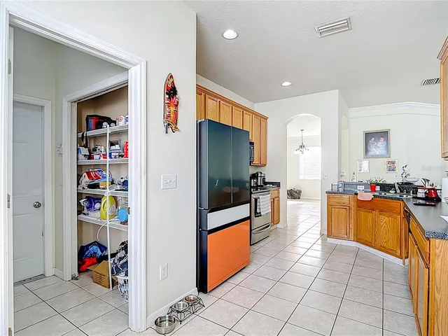 a kitchen with stainless steel appliances a refrigerator and a stove