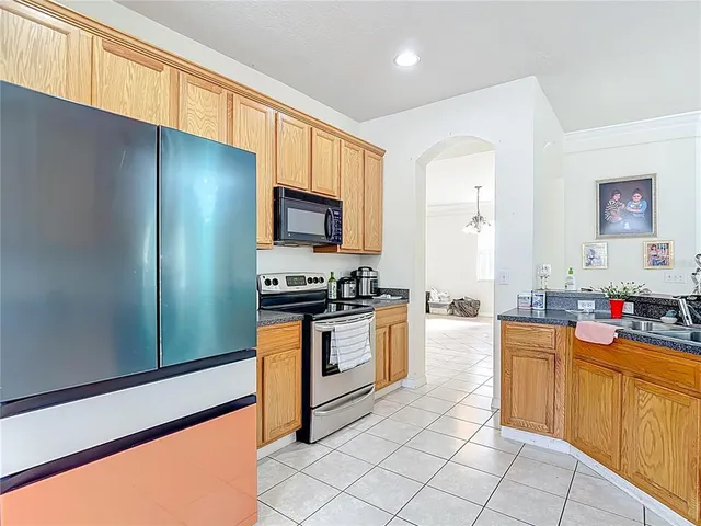 a kitchen with stainless steel appliances a stove refrigerator sink and cabinets