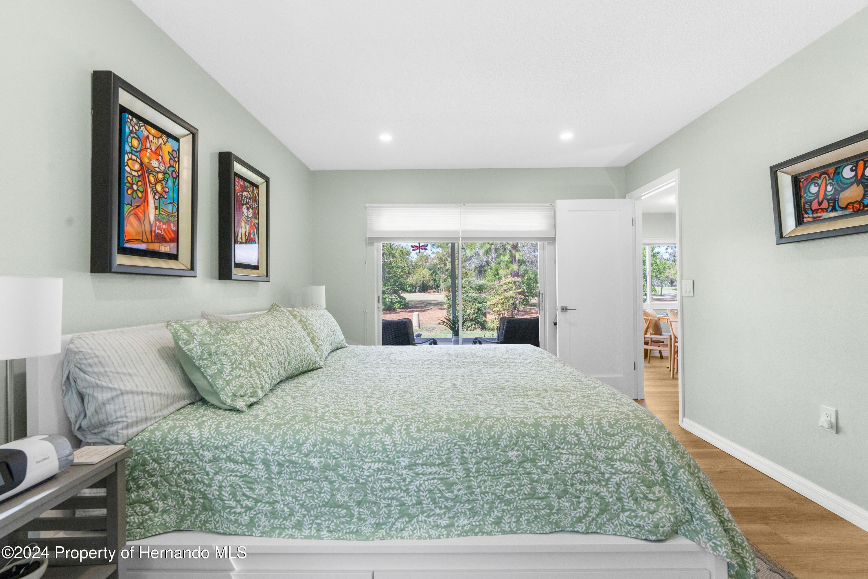 7566 St Andrews Boulevard Weeki Wachee, FL 34613 - Photo 11 of 38 a large bedroom with a bed and glass window