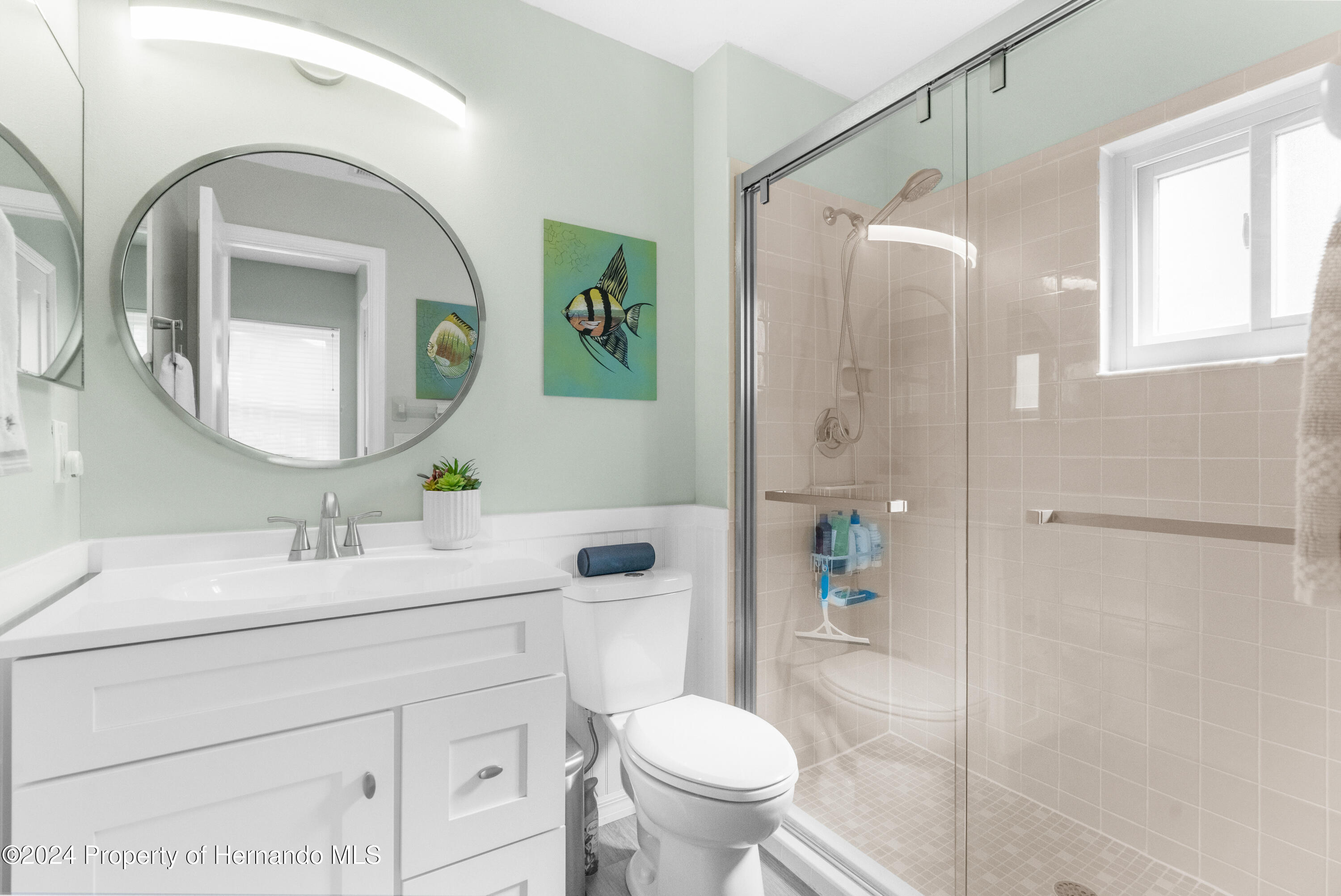 7566 St Andrews Boulevard Weeki Wachee, FL 34613 - Photo 12 of 38 a bathroom with a toilet sink and shower