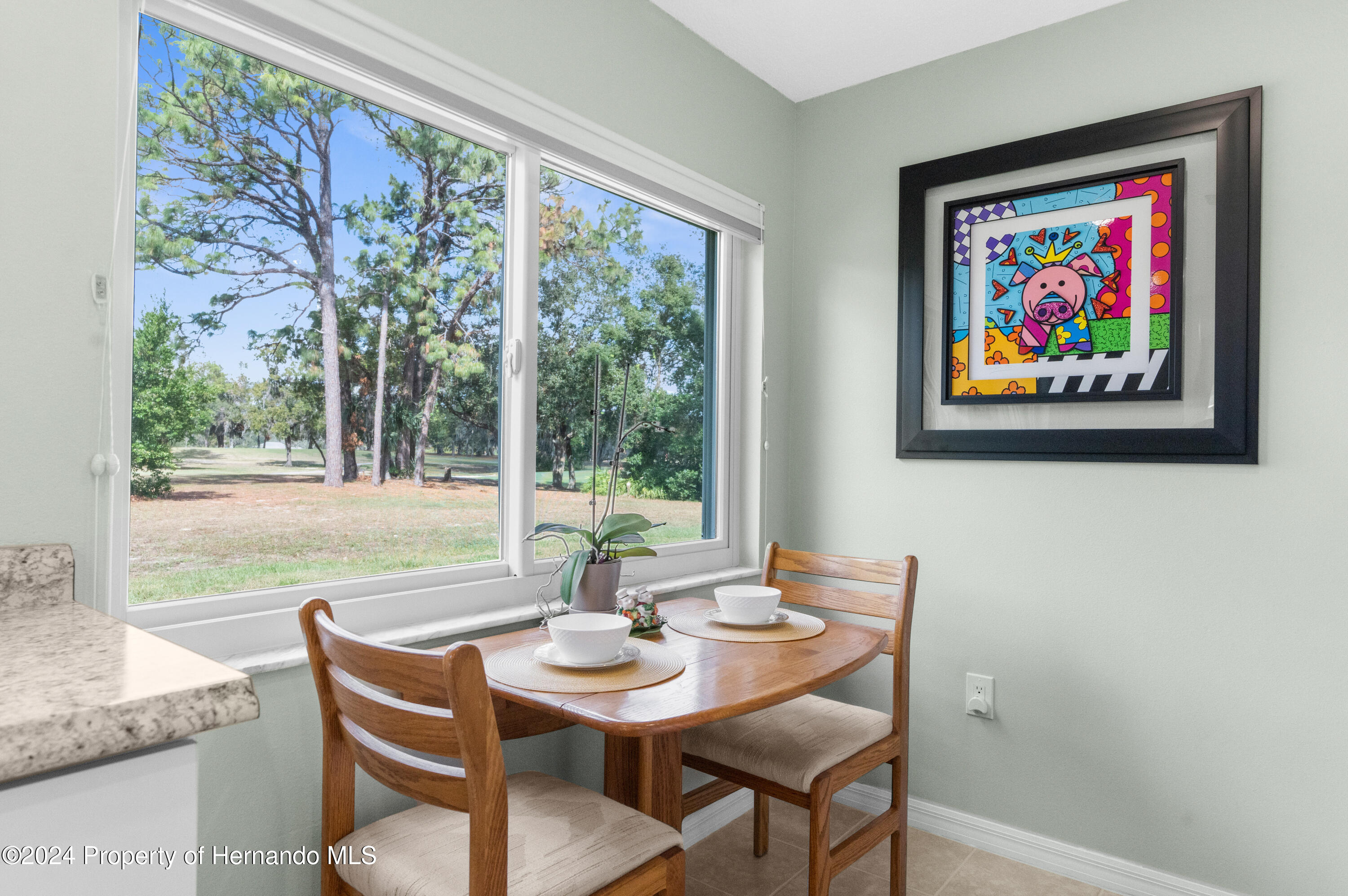 7566 St Andrews Boulevard Weeki Wachee, FL 34613 - Photo 17 of 38 a view of a dining room with furniture large window and outside view
