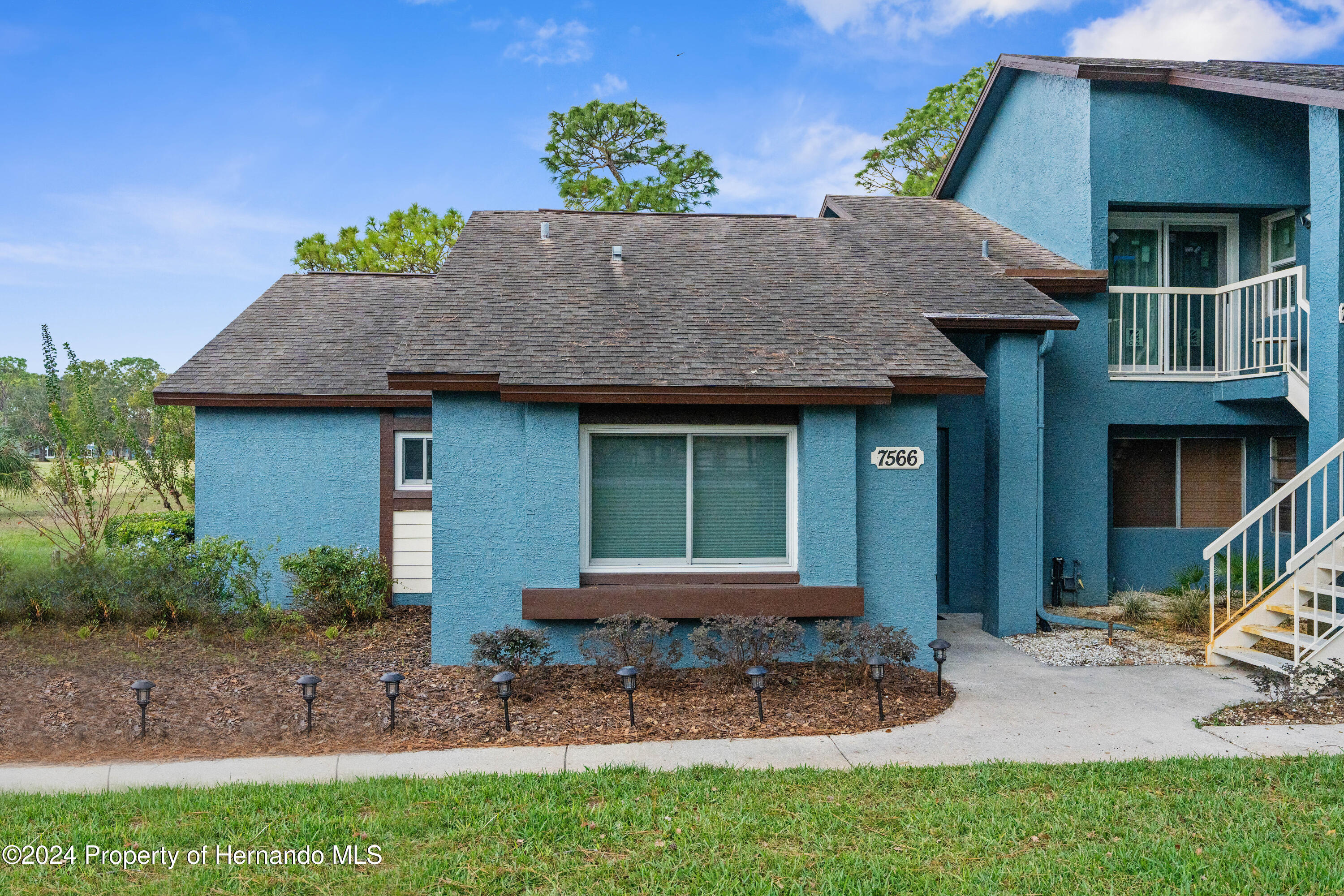 7566 St Andrews Boulevard Weeki Wachee, FL 34613 - Photo 30 of 38 a front view of a house with a porch