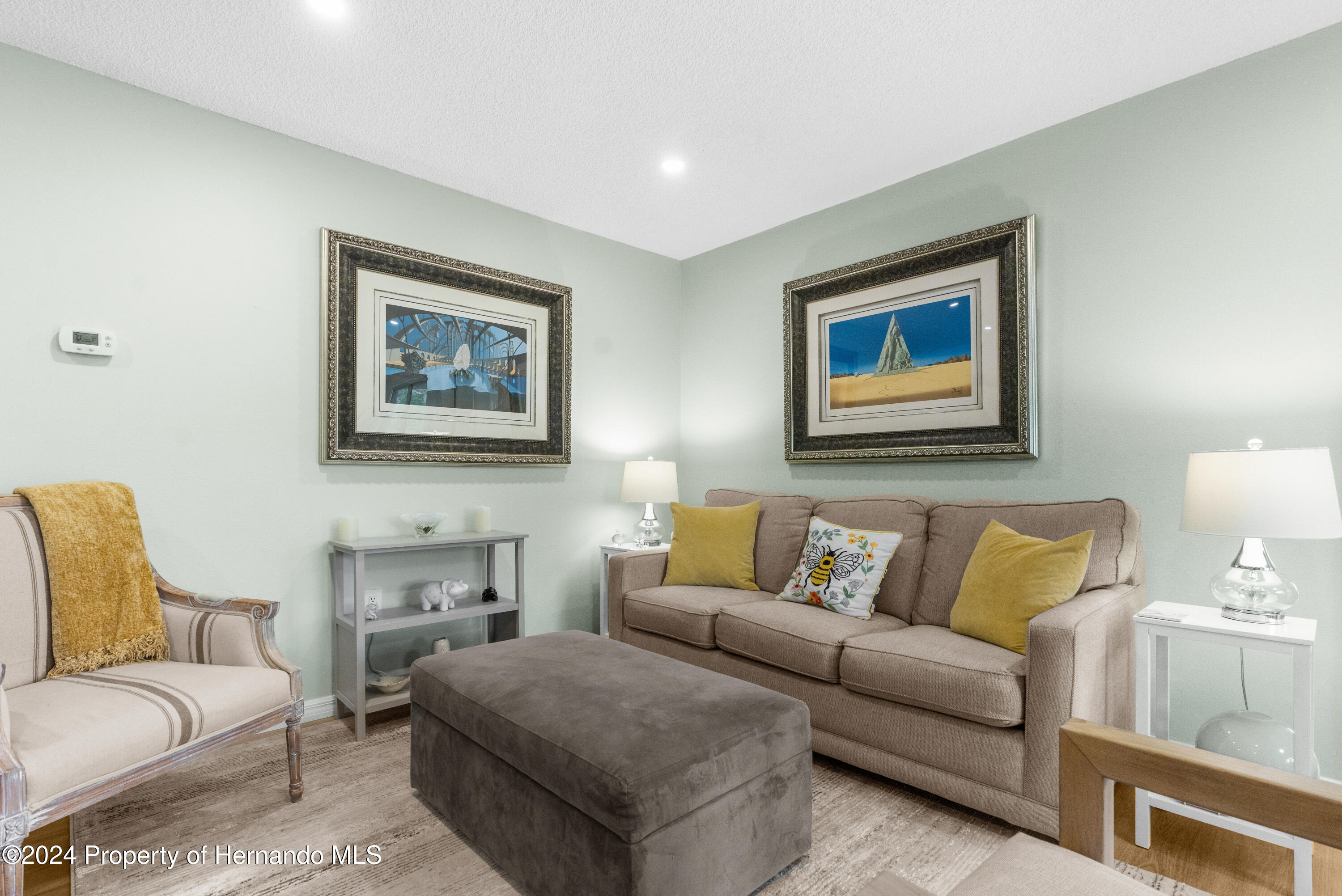 7566 St Andrews Boulevard Weeki Wachee, FL 34613 - Photo 7 of 38 a living room with furniture and a couch