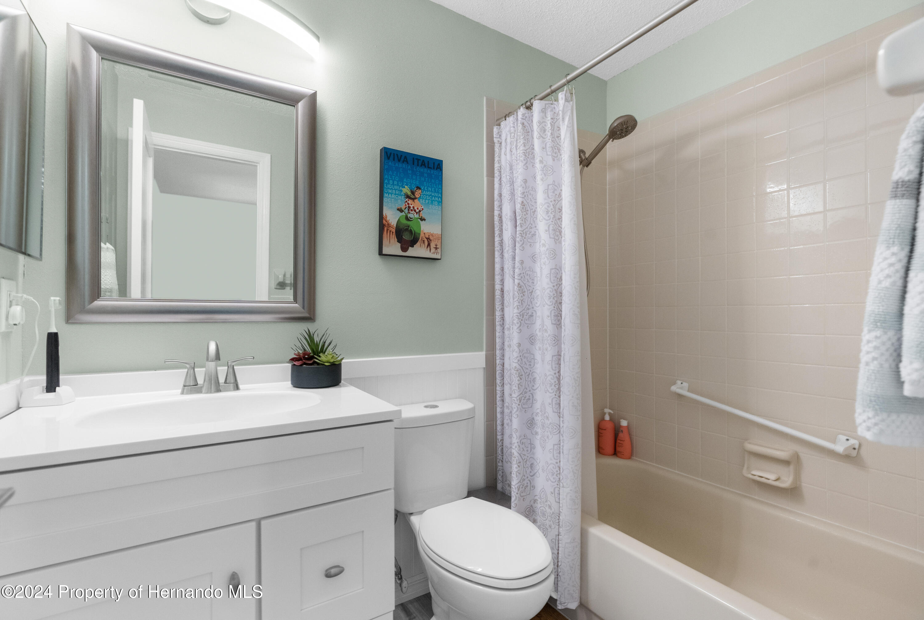 7566 St Andrews Boulevard Weeki Wachee, FL 34613 - Photo 8 of 38 a bathroom with a sink a toilet and shower