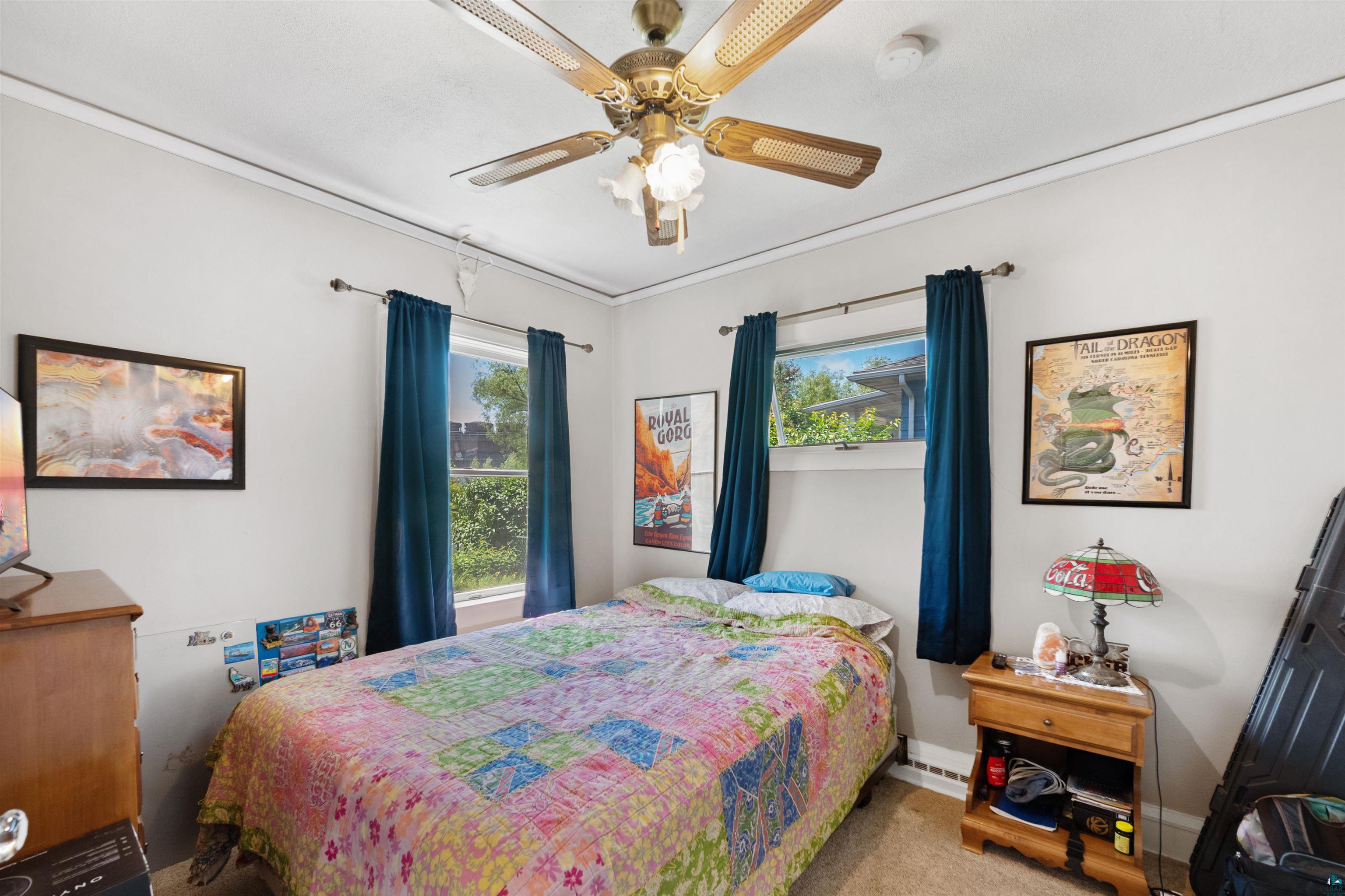 3209 Chestnut Street Duluth, MN 55806 - Photo 10 of 28 Bright room featuring a ceiling fan with integrated lighting, two windows with natural light, and neutral wall tones