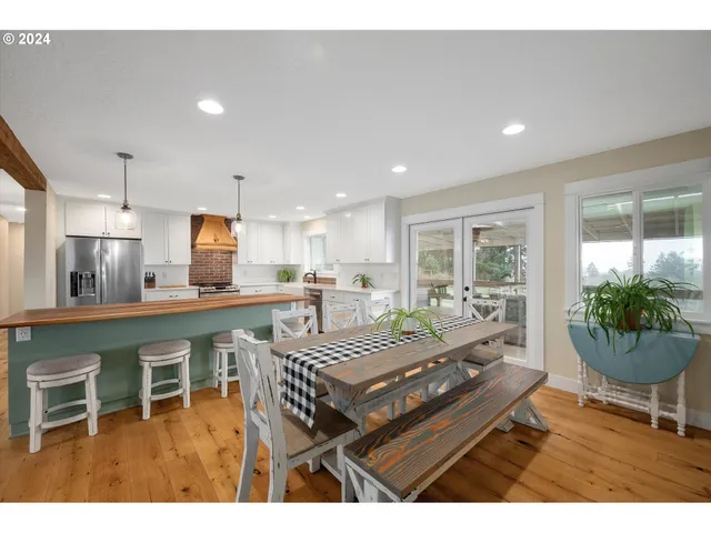 a living room with furniture a dining table and a potted plant