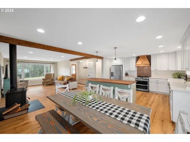 a living room with furniture a flat screen tv and kitchen view