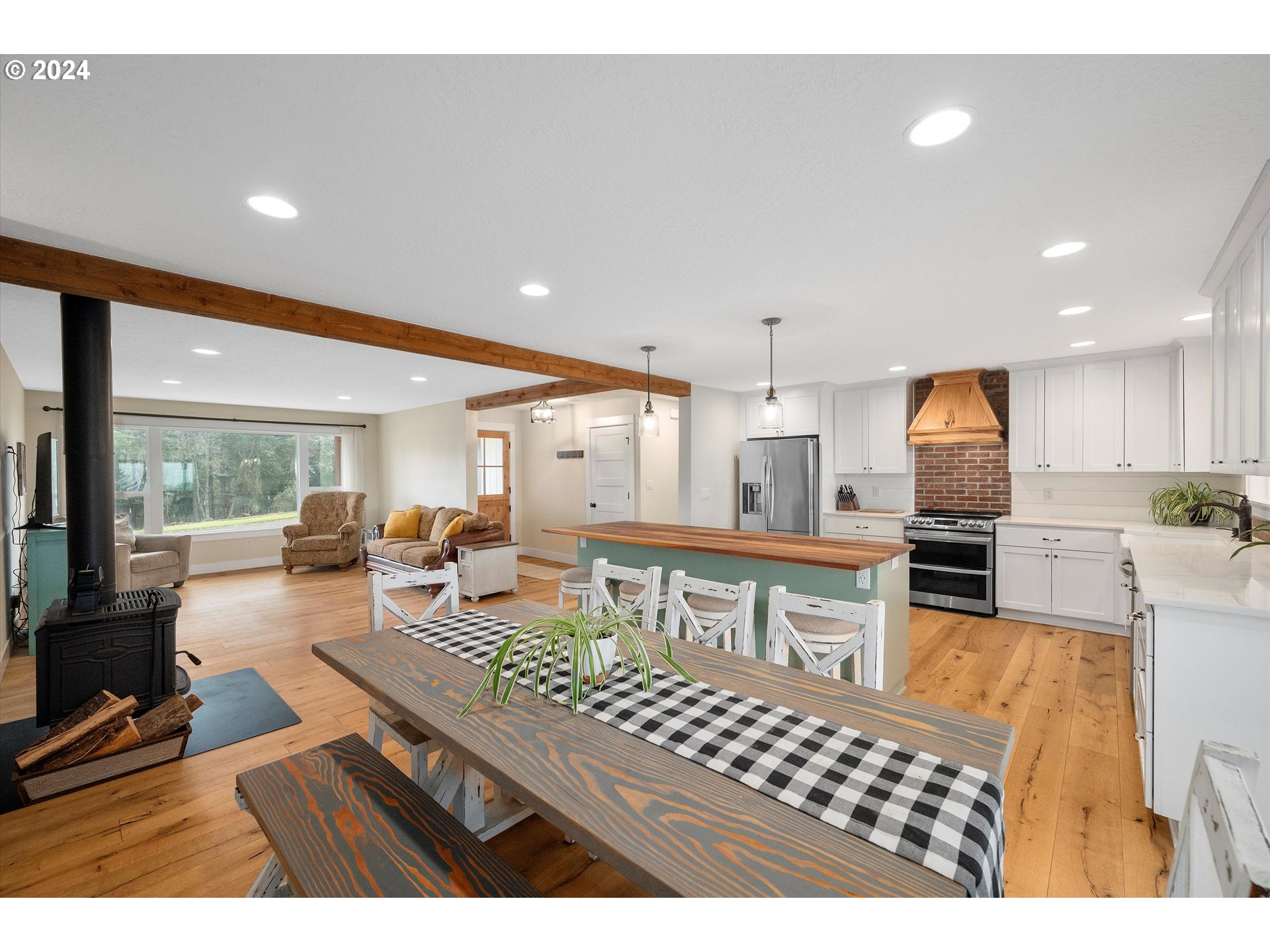 7625 Southeast Seawood Road Amity, OR 97101 - Photo 15 of 48 a living room with furniture a flat screen tv and kitchen view