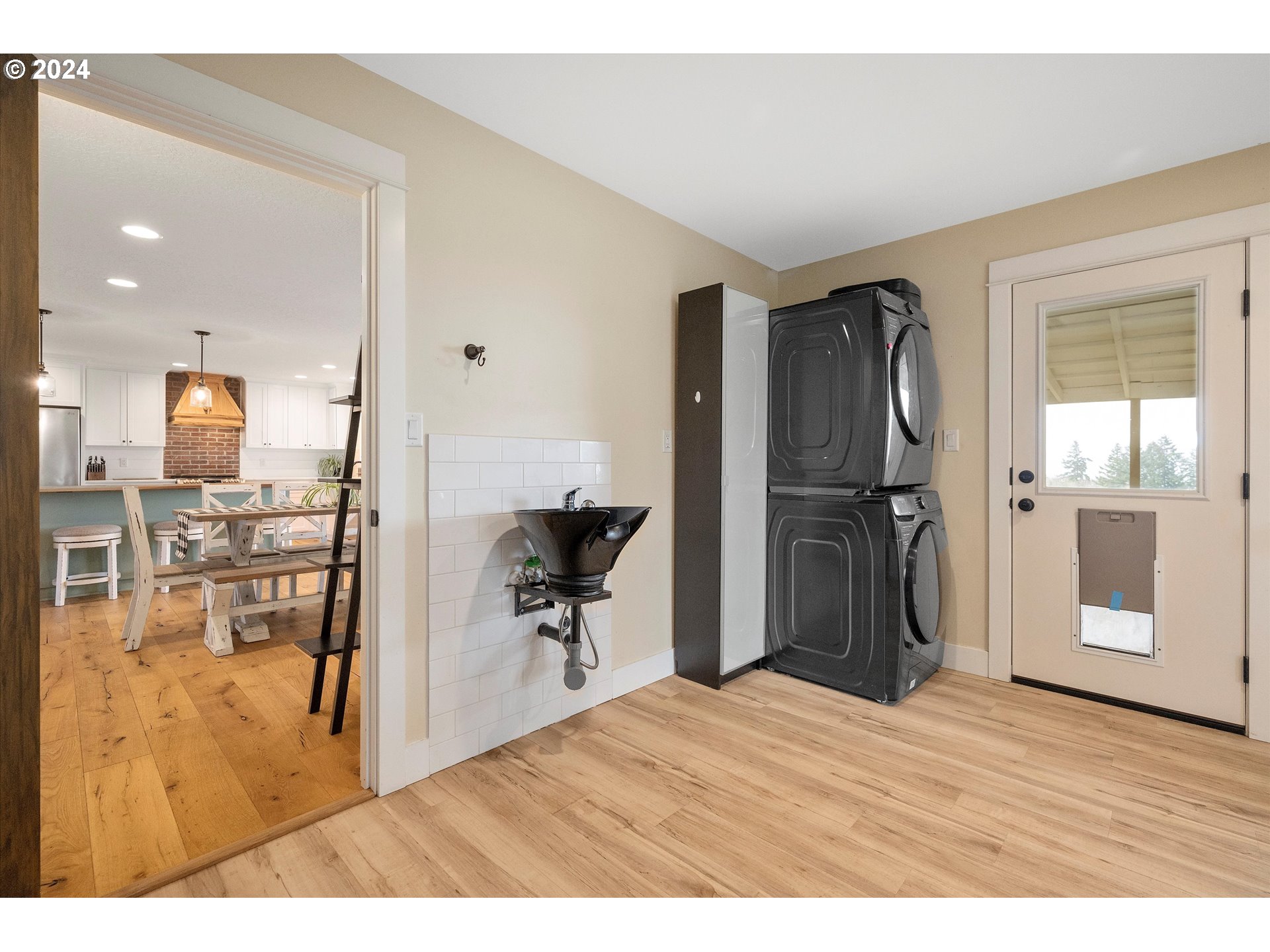 7625 Southeast Seawood Road Amity, OR 97101 - Photo 18 of 48 a open kitchen with stainless steel appliances kitchen island granite countertop a refrigerator and a sink