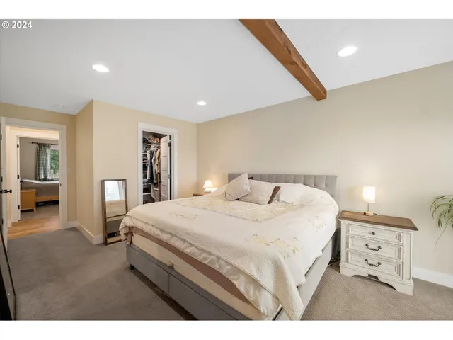 a bedroom with a bed and a large mirror