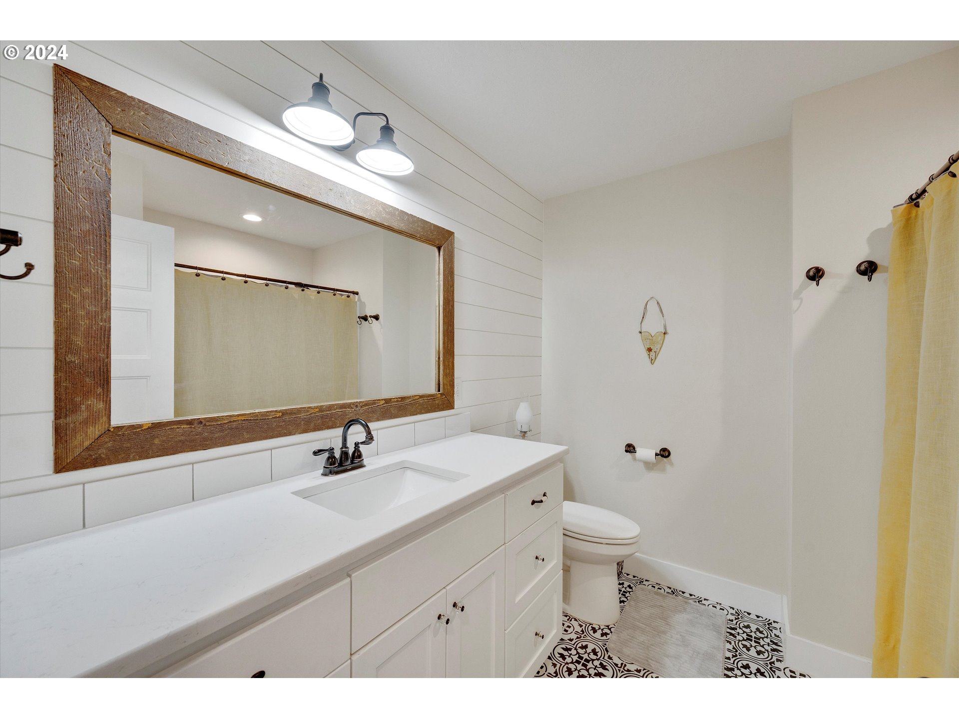 7625 Southeast Seawood Road Amity, OR 97101 - Photo 26 of 48 a bathroom with a sink a toilet a mirror and shower