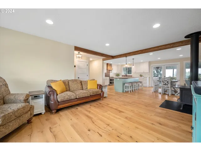 a living room with furniture and view of kitchen