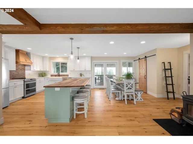 a living room with lots of furniture and kitchen view