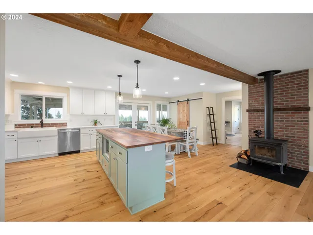 a kitchen with stainless steel appliances kitchen island granite countertop a large counter top and view of living room