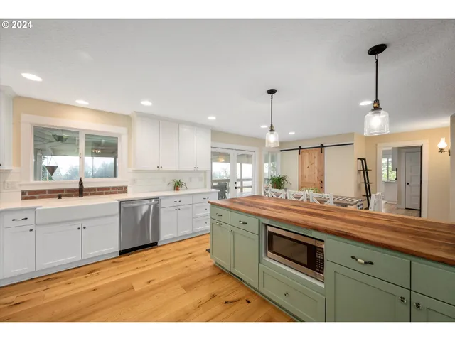 a kitchen with stainless steel appliances granite countertop a sink and stove top oven