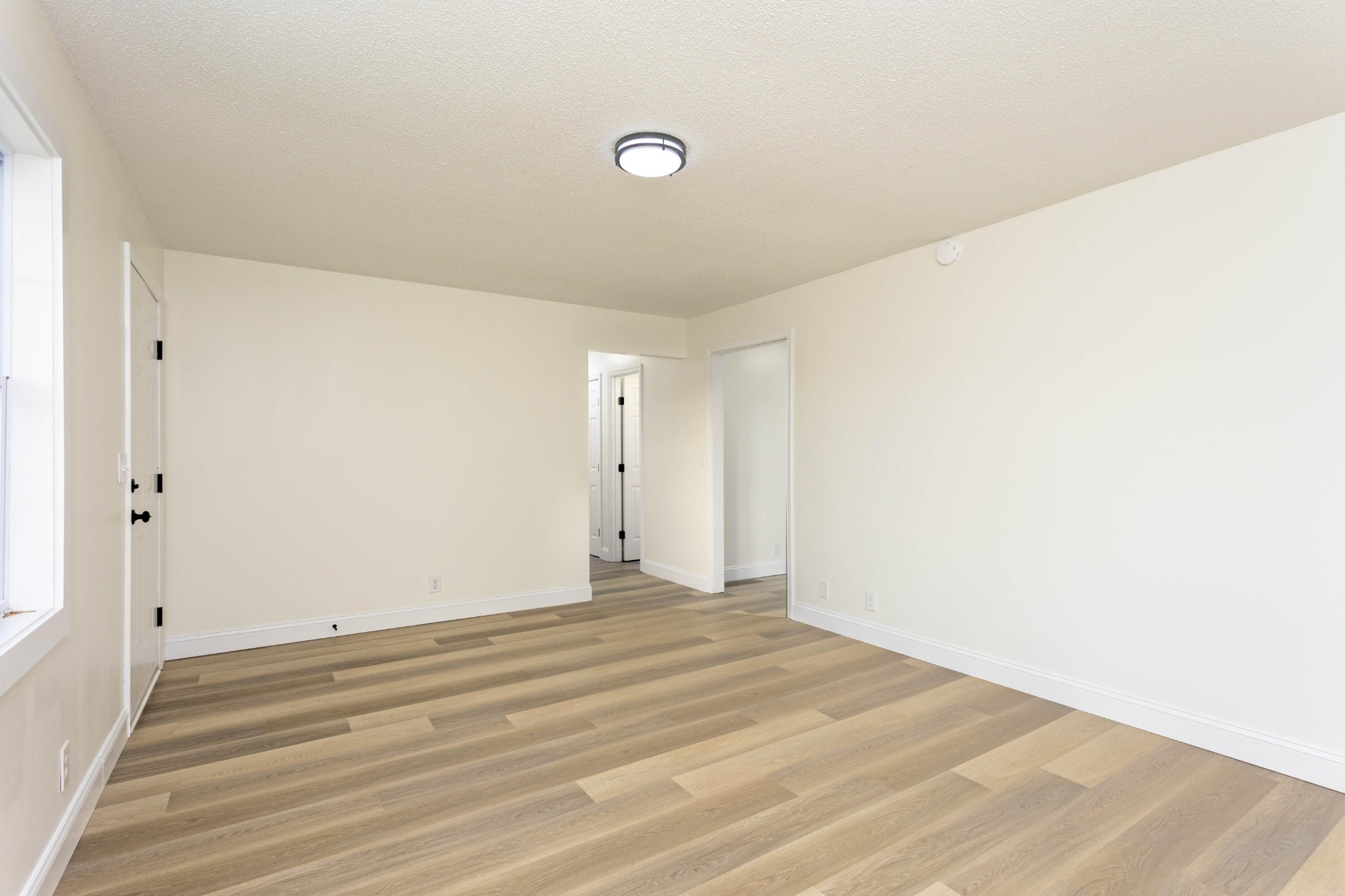 132 Walnut Street Spring City, TN 37381 - Photo 12 of 26 a view of a room with wooden floor and white walls