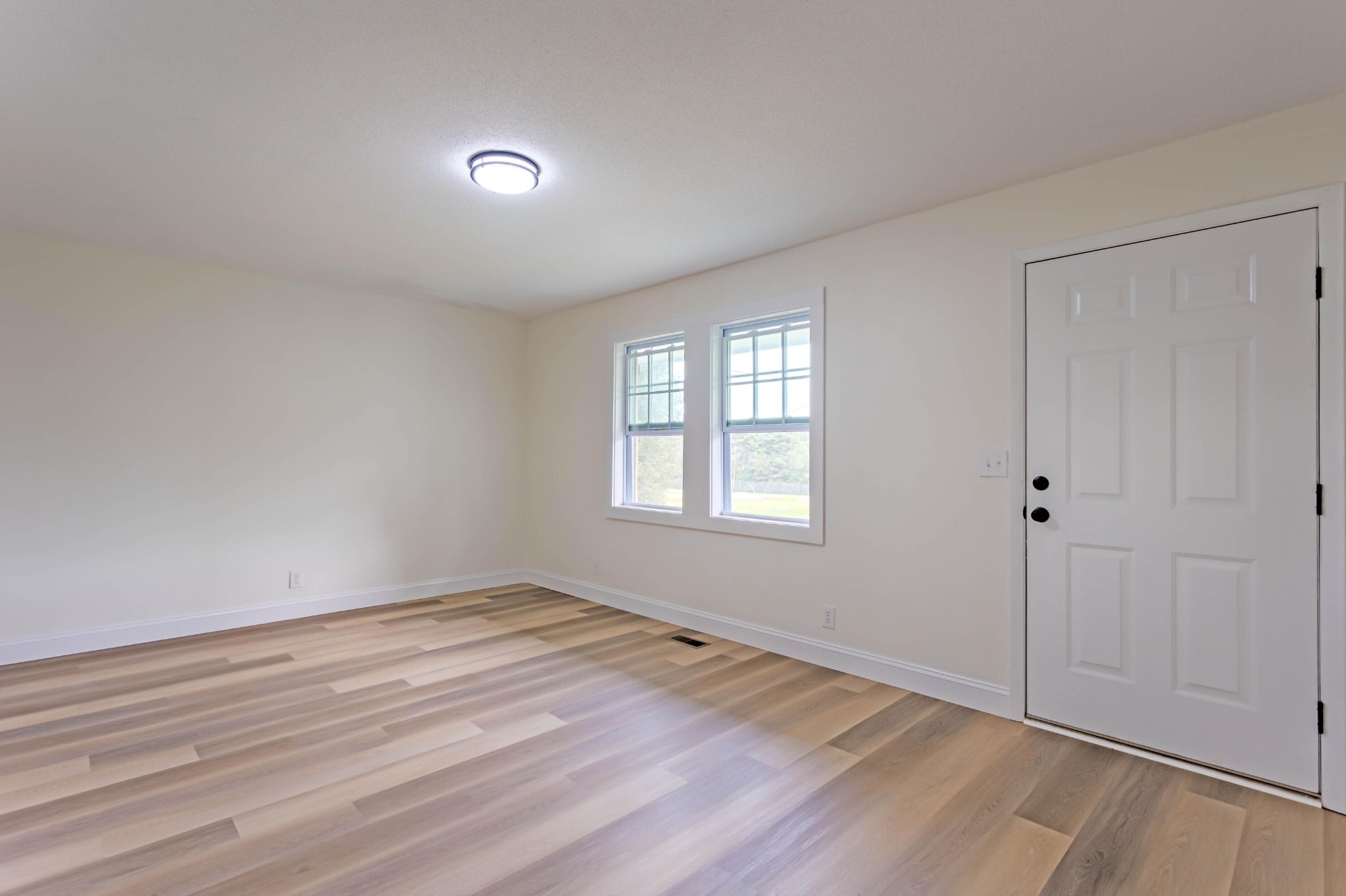 132 Walnut Street Spring City, TN 37381 - Photo 13 of 26 a view of an empty room with wooden floor and a window