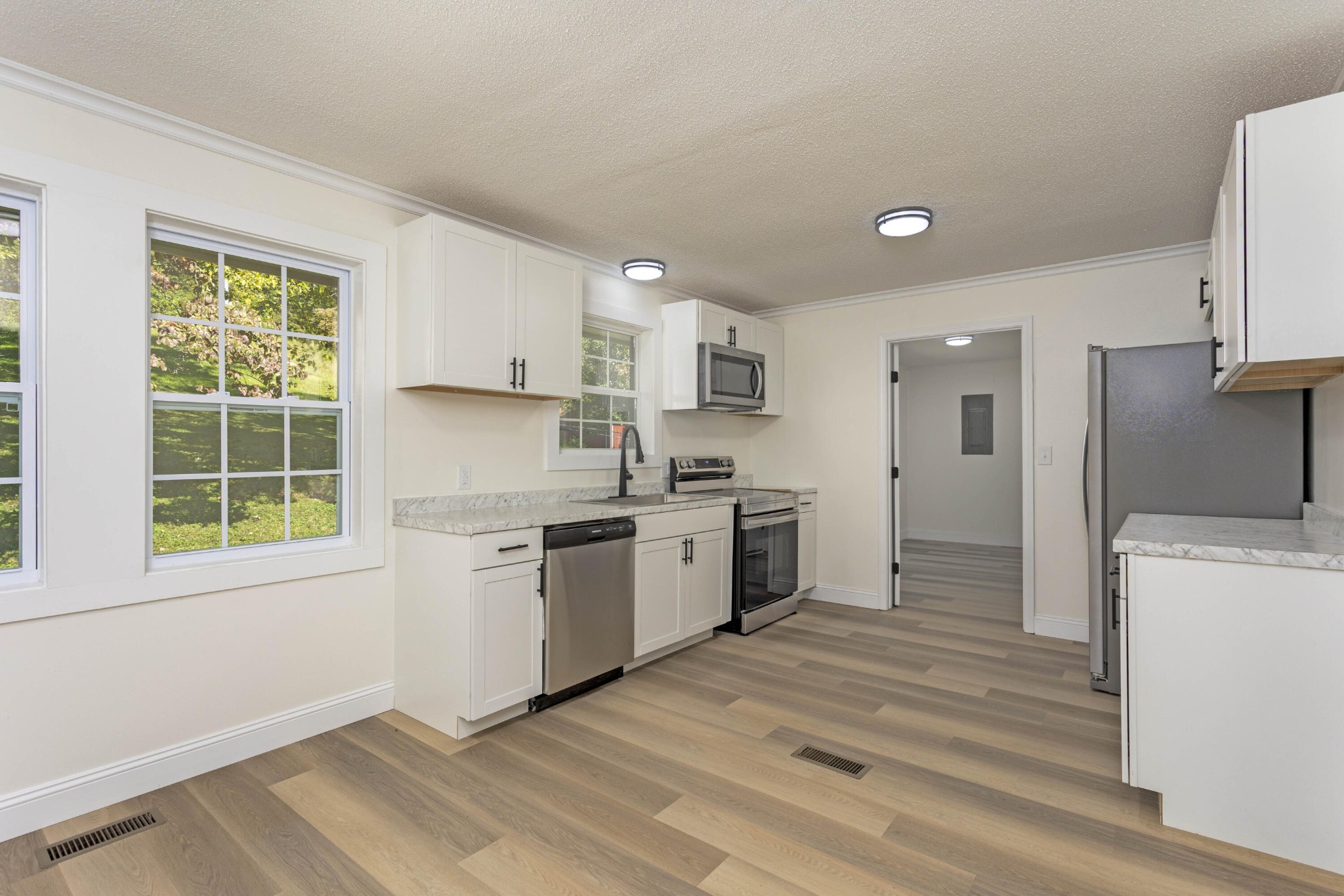 132 Walnut Street Spring City, TN 37381 - Photo 5 of 26 a kitchen with a refrigerator stove top oven and sink