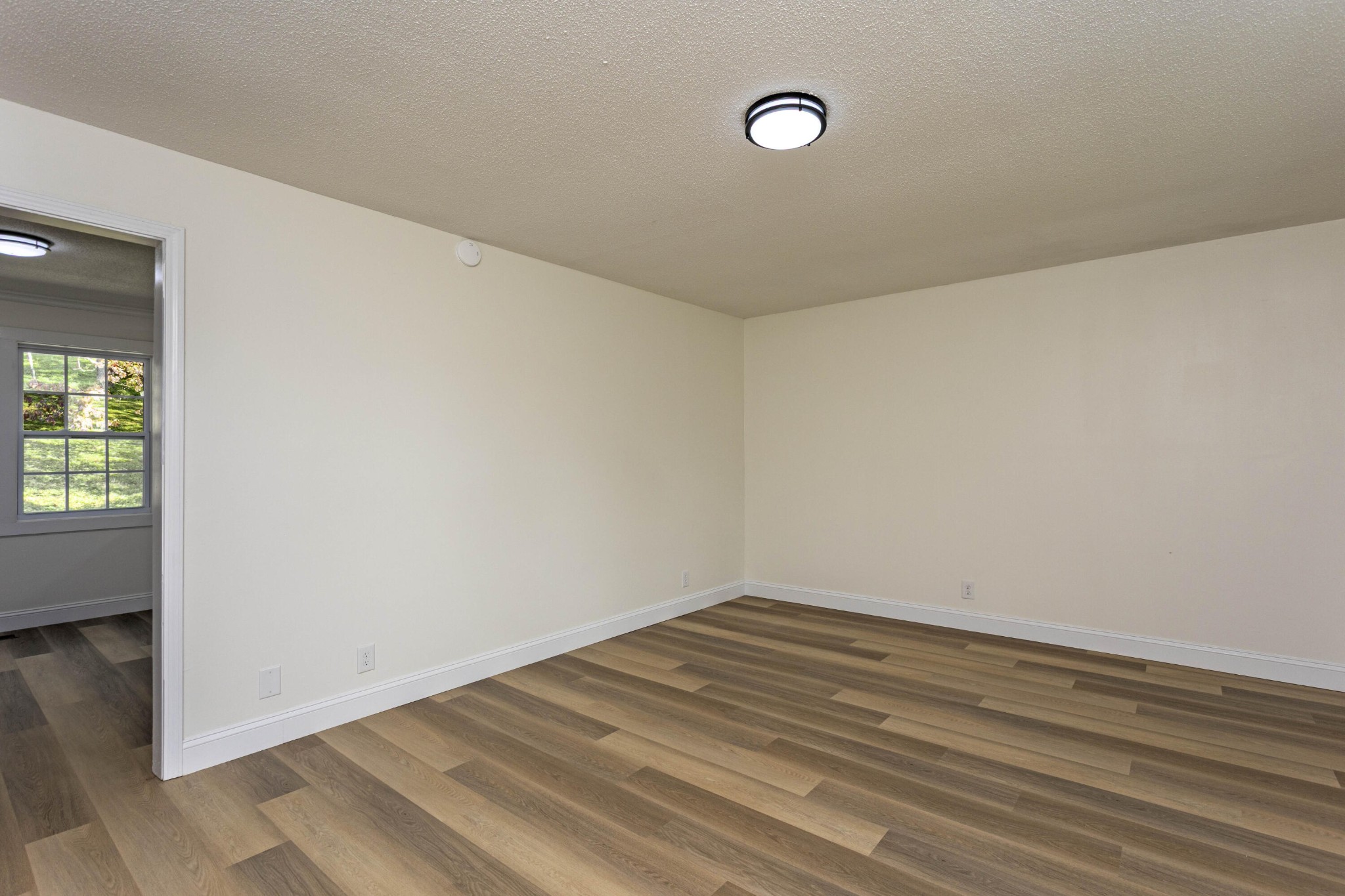 132 Walnut Street Spring City, TN 37381 - Photo 10 of 26 a view of a room with wooden floor and white walls