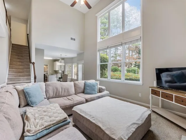 a kitchen with granite countertop white cabinets and a sink