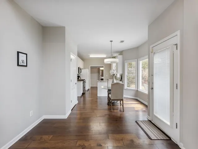 a kitchen with a refrigerator and a stove top oven