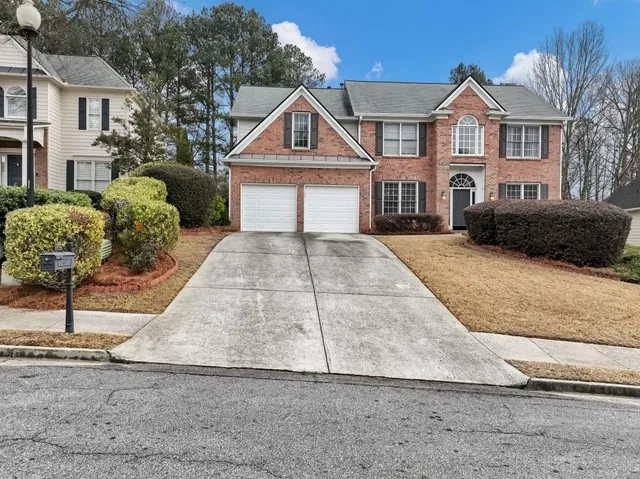 a front view of a house with a yard