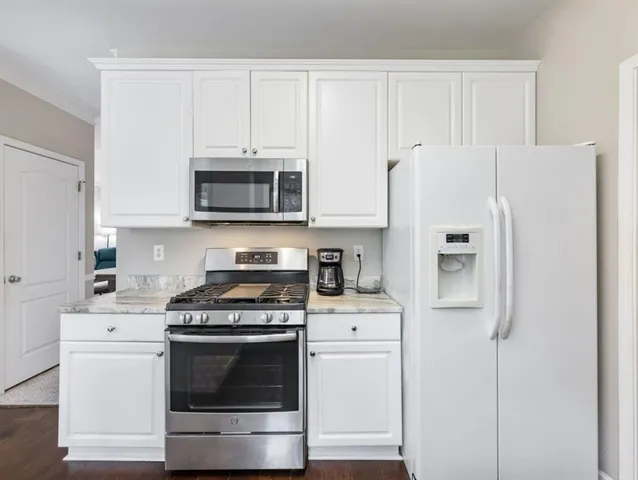 a spacious bathroom with a double vanity sink mirror and a bathtub