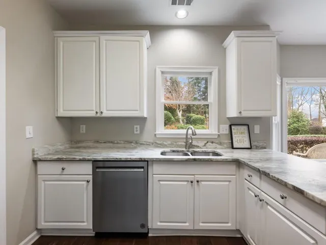 a bathroom with a granite countertop sink a large mirror and a bathtub