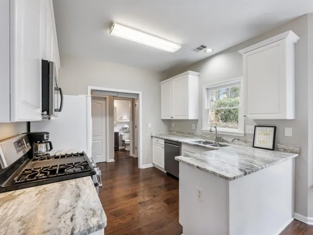 a bathroom with a sink mirror and a bathtub
