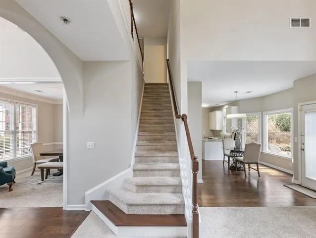 a bedroom with a large bed and a ceiling fan