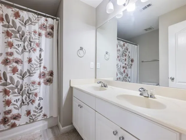 a view of backyard with wooden fence and trees