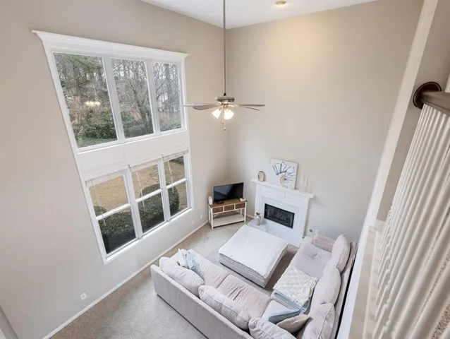 a view of a fire pit with a house in the background