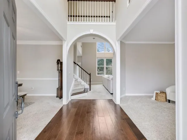 a dining room with furniture a chandelier and wooden floor