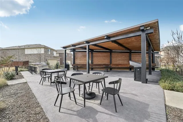 a view of a patio with a table and chairs
