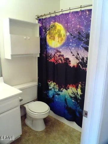 a bathroom with a granite countertop sink and mirror